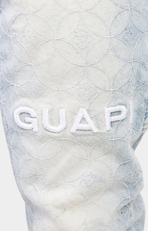 Raised GUAPI applique logo on aqua blue sashiko denim.