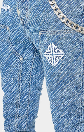 Close-up embroidered GUAPI logo waistband on Royal Blue Striker Denim.