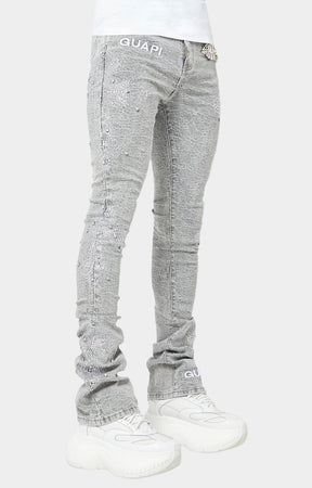 Smoke Grey stacked skinny jeans with embroidered GUAPI waistband logo.