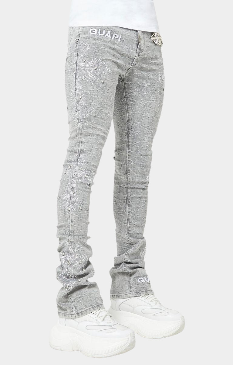 Smoke Grey stacked skinny jeans with embroidered GUAPI waistband logo.