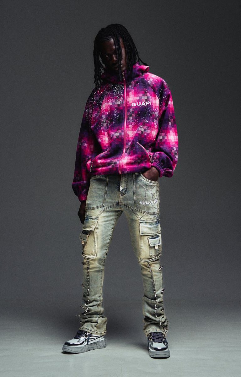 Guapi grey cargo jeans with decorative spike trim heavily distressed light-wash cargo jeans and gray platform sneakers.