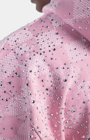 Close-up of GUAPI logo on French Rose Stardust hoodie.