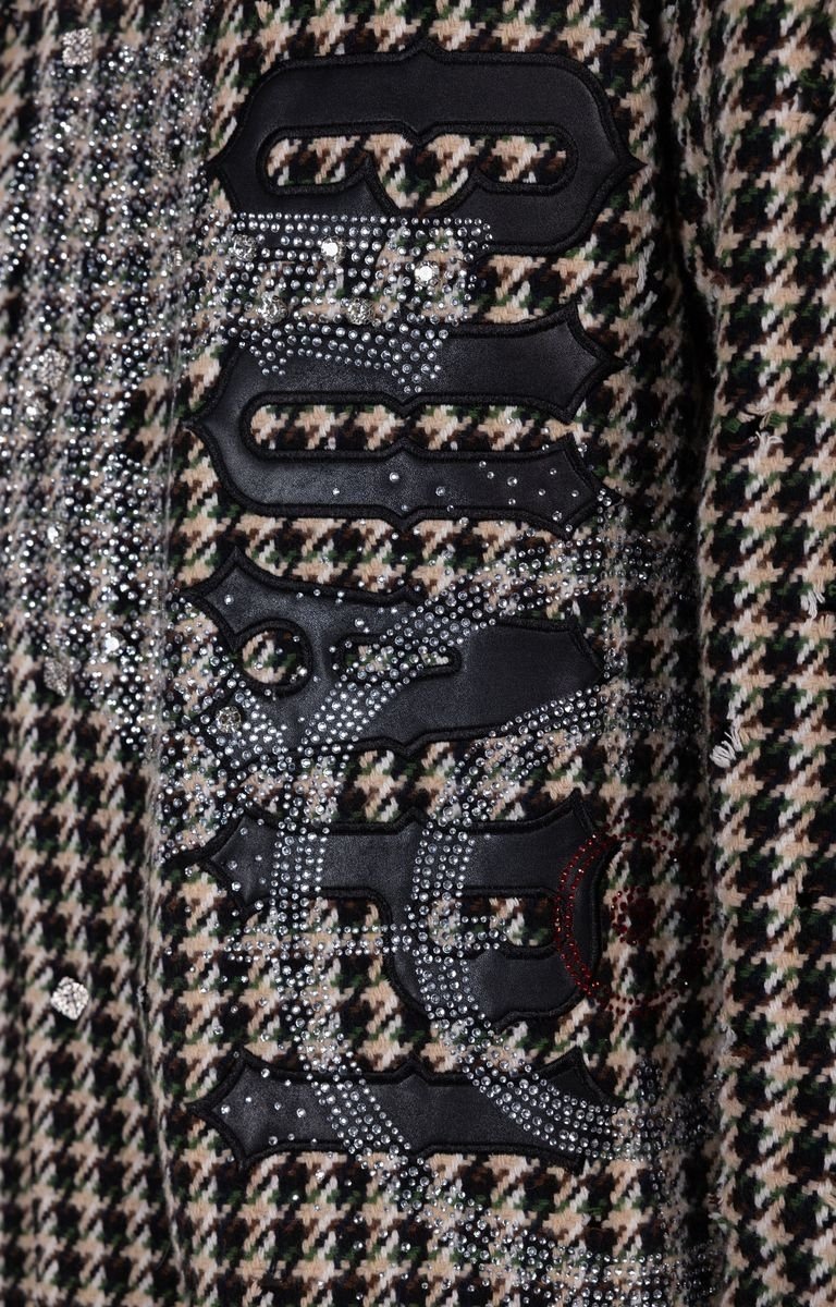 Detailed view of bold appliqué graphics on GUAPI shirt jacket.