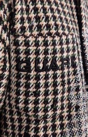 Detailed view of bold embroidery logo on GUAPI shirt jacket.