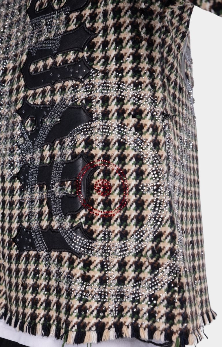 Close-up of hand-applied rhinestone embellishments on GUAPI Still A Threat shirt.