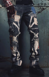 Guapi Vintage Black Chronicle Denim featuring a black base, multicolor collage-inspired prints, splatter effects, slim tailored fit, five-pocket construction and button-zip closure.