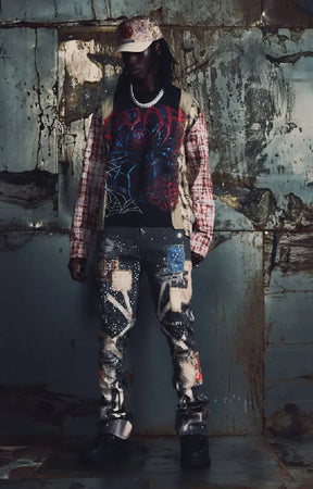 Guapi Vintage Black Chronicle Denim featuring a black base, multicolor collage-inspired prints, splatter effects, slim tailored fit, five-pocket construction and button-zip closure.