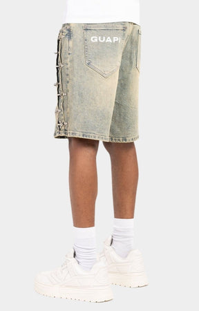 Back view of GUAPI vintage washed blue denim shorts knee length.