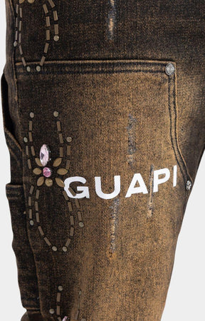 GUAPI logo print on upper thigh of Guapi Vintage Brown Denim 