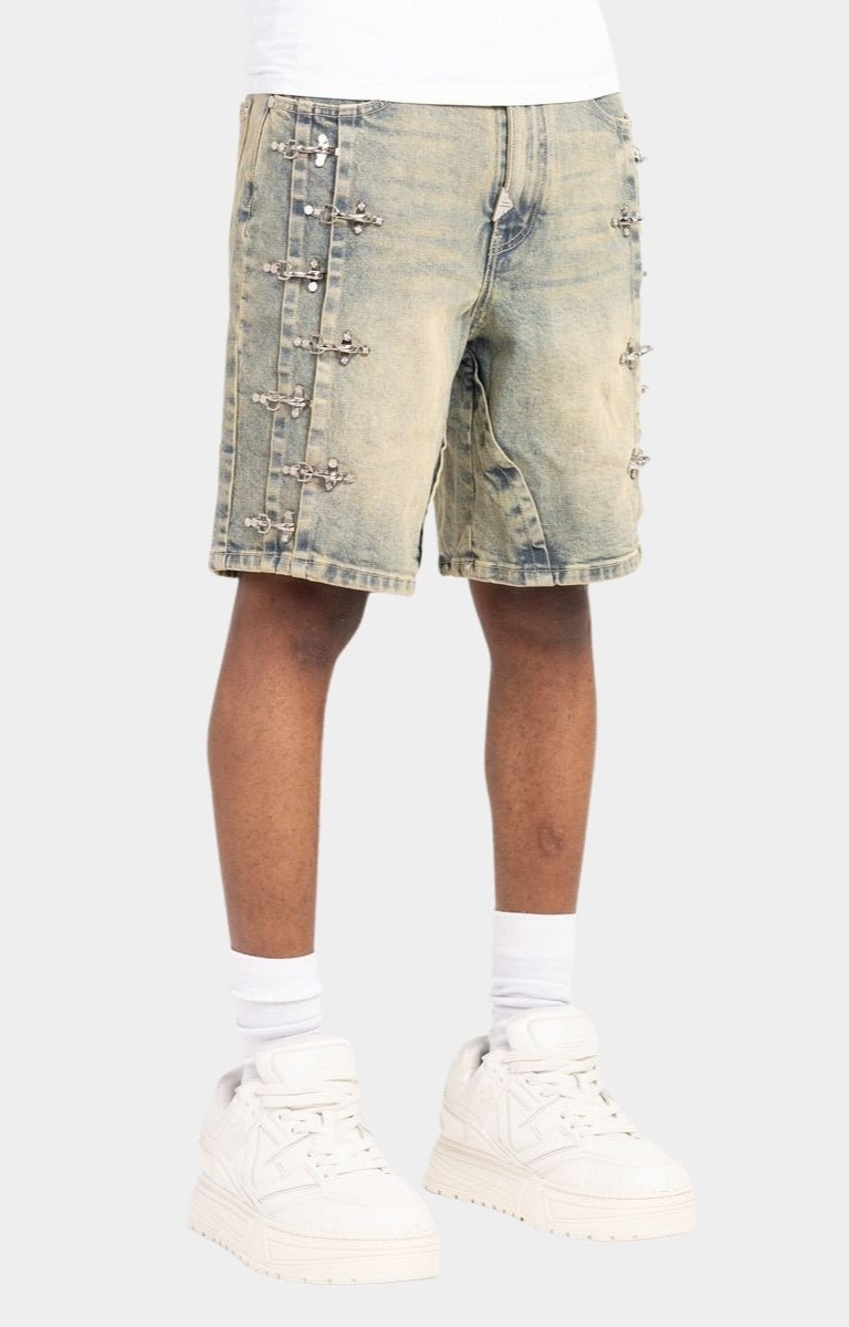 Detailed texture of vintage blue washed denim fabric on GUAPI shorts.