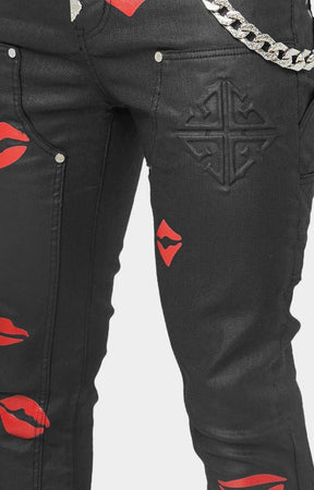 Silver-tone chain detail on GUAPI stacked jeans.