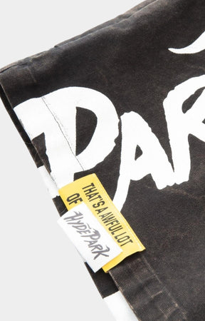 Hyde Park x ALOCS collaboration logo detail on black carpenter shorts.