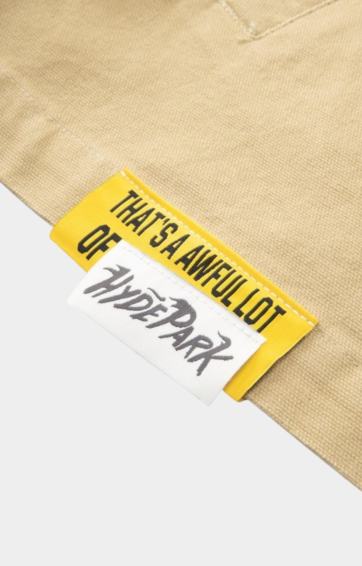 Hyde Park and ALOCS collaborative branding on khaki mechanic shirt.