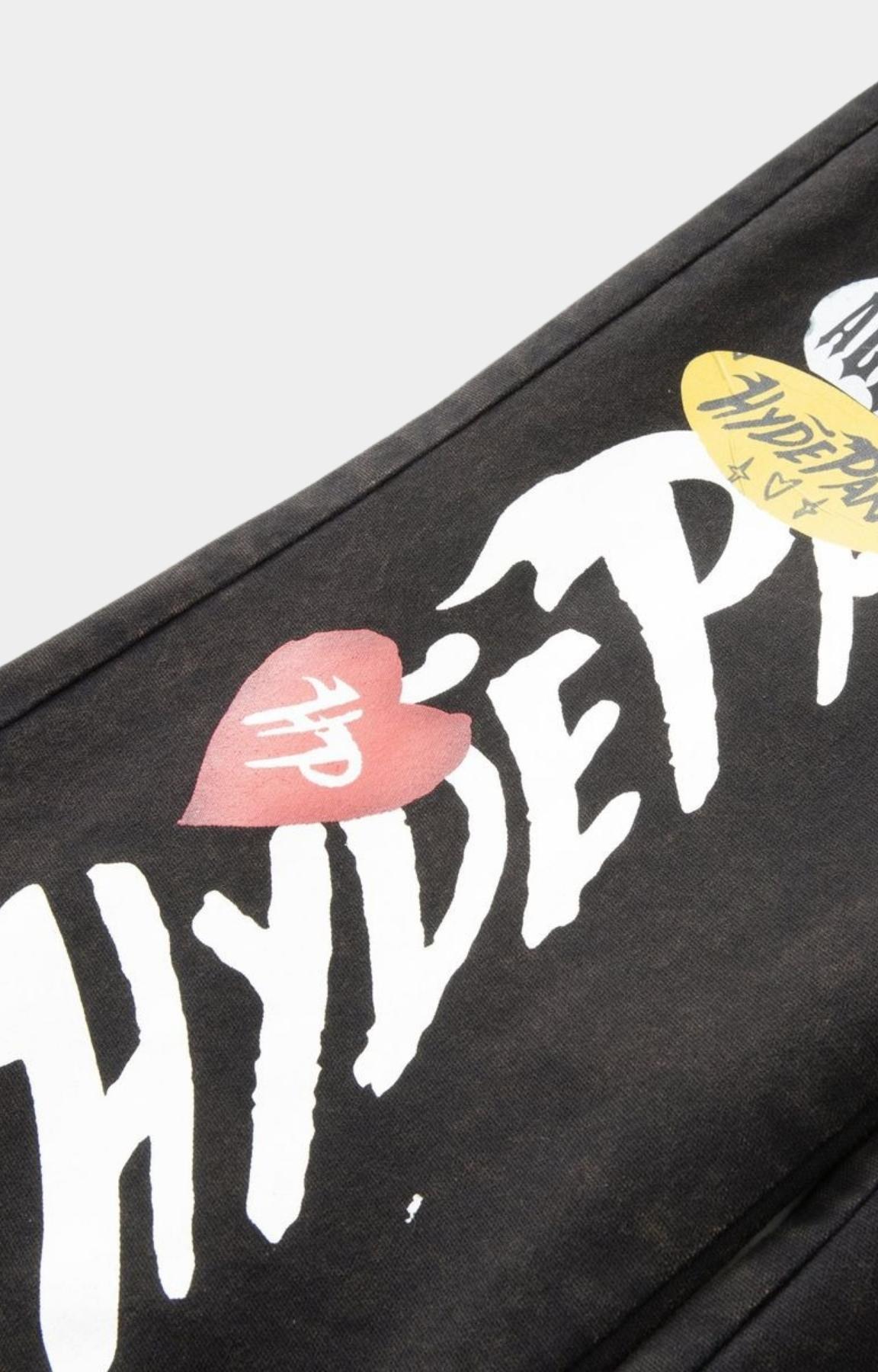 Hyde Park x ALOCS collaboration logo detail on black workwear trousers.