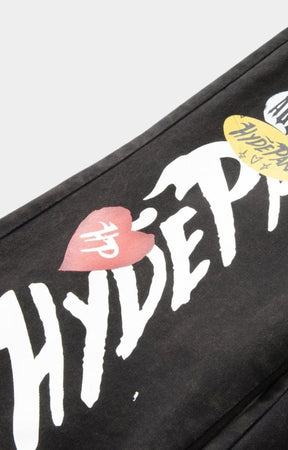Hyde Park x ALOCS collaboration logo detail on black workwear trousers.
