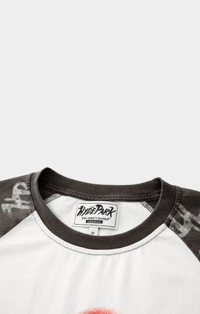 Close-up of a shirt with a brand label with a ribbed crewneck. 