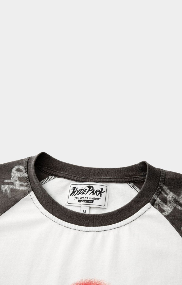 Close-up of a shirt with a brand label with a ribbed crewneck. 