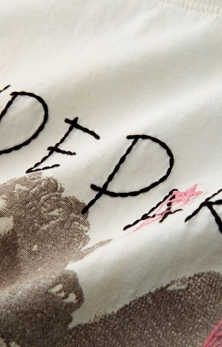 Hyde Park Get Off My Cloud Oversized and distressed graphic tee with embroidery detail on cream tee
