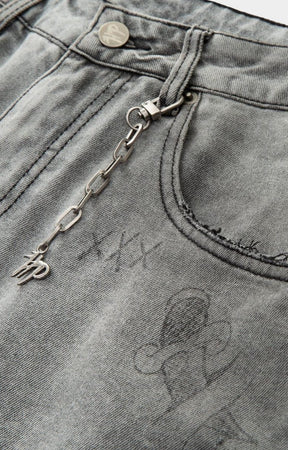 Close-up of a keychain attached to a pocket with visible branding on hyde park gray denim.