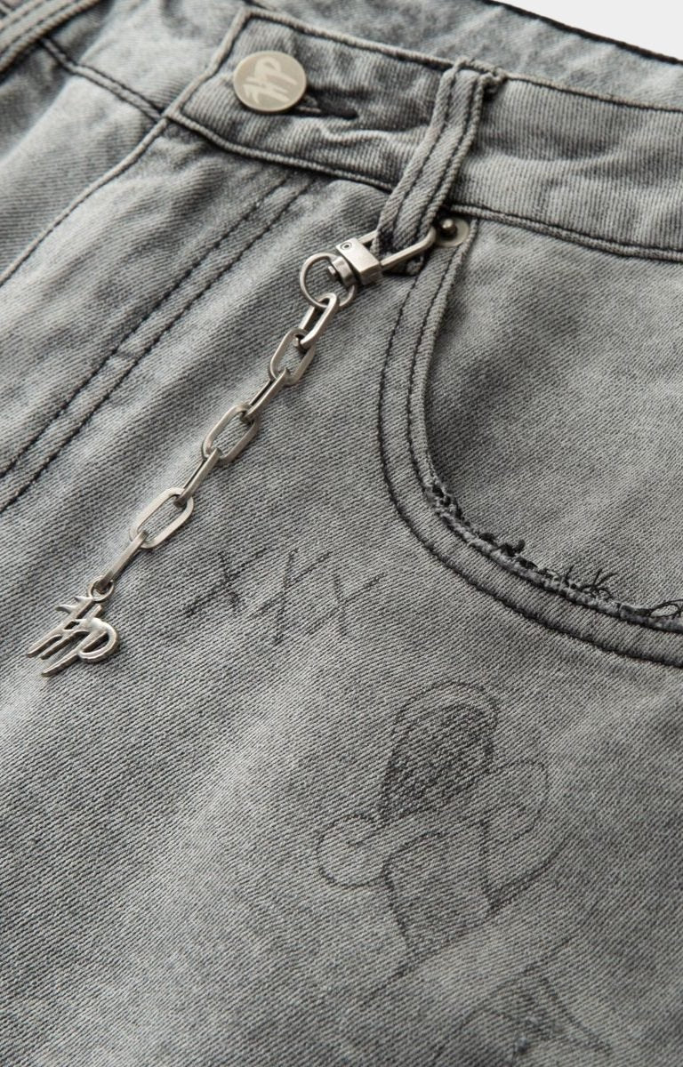 Close-up of a keychain attached to a pocket with visible branding on hyde park gray denim.