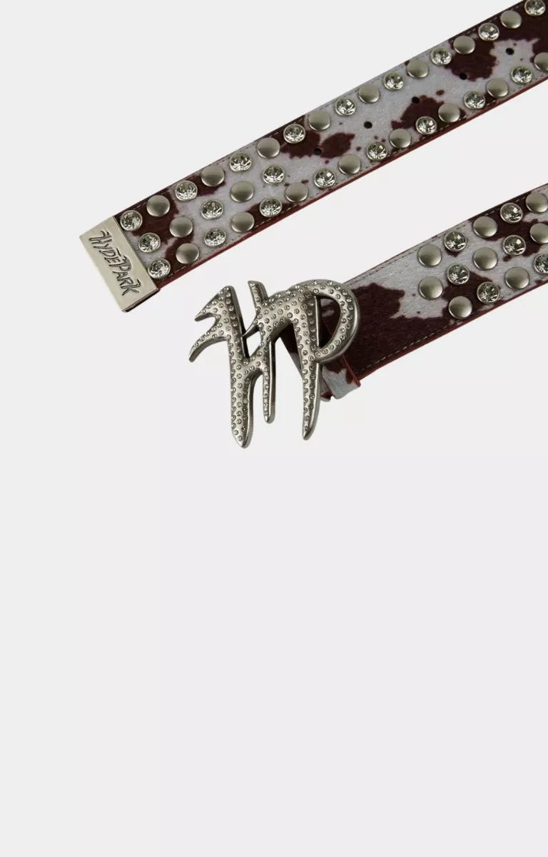 Close-up of buckle and skull detail on Hyde Park cow print belt.