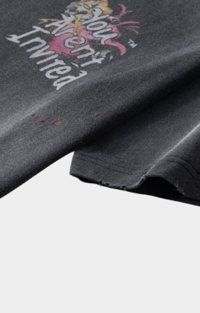 Abstract crayon-style artwork detail on t-shirt with distressed sleeves. 