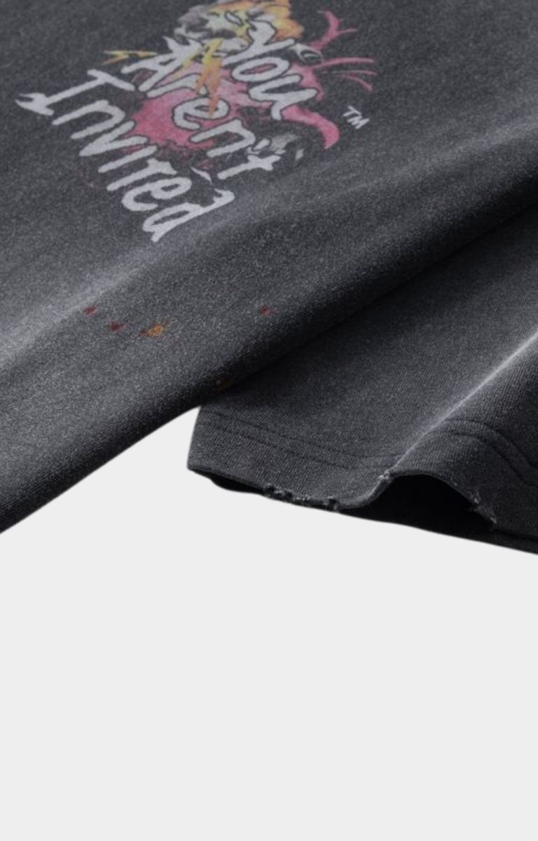 Abstract crayon-style artwork detail on t-shirt with distressed sleeves. 