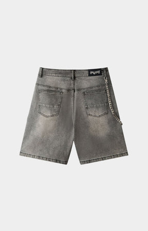Crystal stud embellishment detail on gray denim shorts.