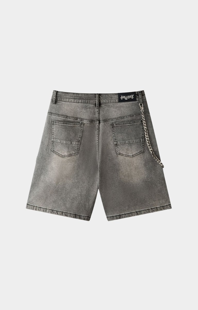 Crystal stud embellishment detail on gray denim shorts.