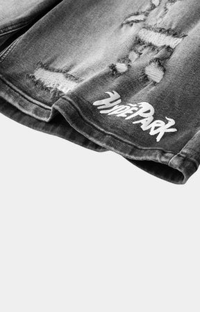 Vintage wash black denim shorts featuring distressed streetwear styling.
