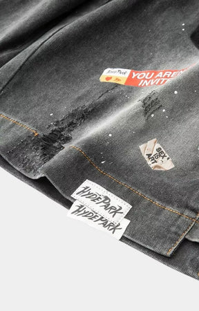 Hyde Park distressed black denim jorts with paint splatter effects.