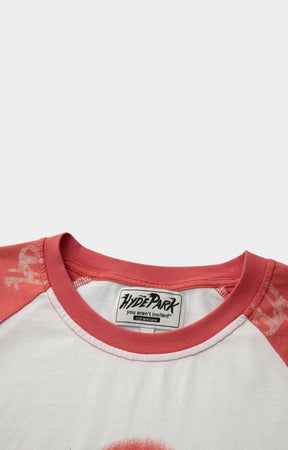 Close-up of a red and white shirt with 'Hyde Park' label with ribbed crewneck. 