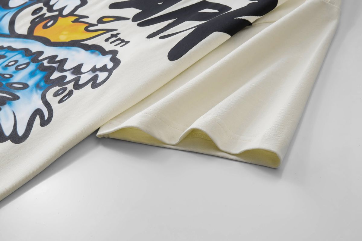 Close-up of a folded fabric with colorful design and text on a light gray background of Hyde Park Tsunami T-shirt