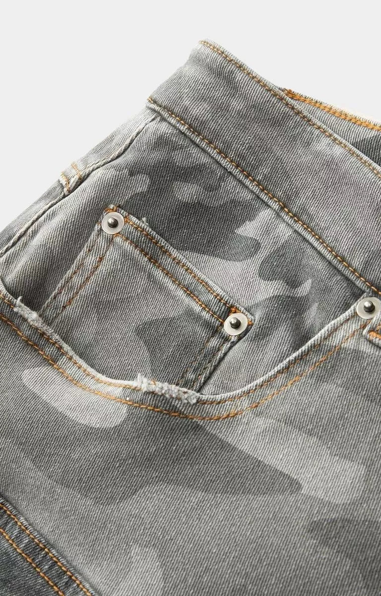 Black patchwork denim jorts by Hyde Park featuring camouflage panel details.