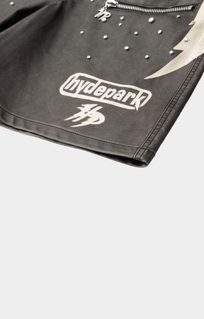 Side graphic panel detail on hyde park black moto racer shorts with logo printed on left side with studs and zipper pocket. 