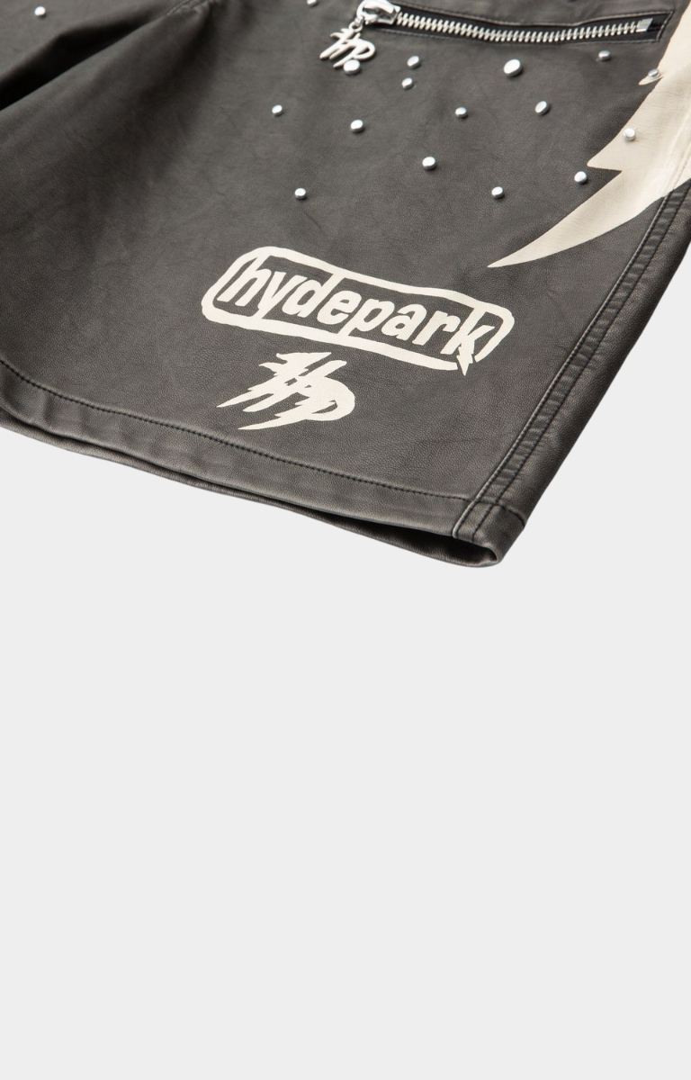 Side graphic panel detail on hyde park black moto racer shorts with logo printed on left side with studs and zipper pocket. 