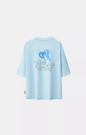 Blue oversized graphic t-shirt with stencil heart design back view. 