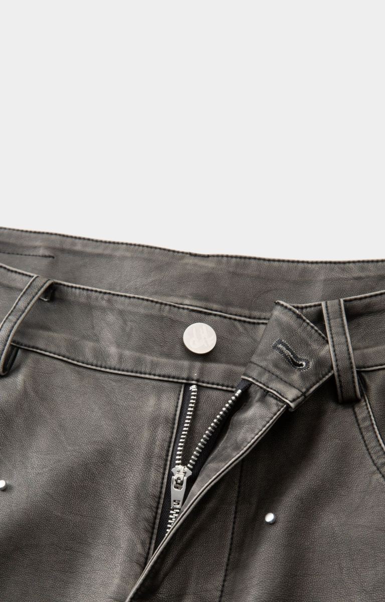 Waistband and button closure detail with front zip closure on hyde park moto racer shorts-black. 
