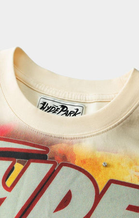 Close-up of a beige t-shirt with a colorful graphic design and 'Hyde Park' label.