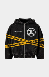 Shop the JETLYFE Bad Influence Hoodie in black, featuring a faded finish, distressed detailing, bold yellow “Bad Influence” graphics across the front and sleeves, chest branding, a full-zip front, attached hood, and front pockets. A statement streetwear piece for pairing with denim, cargo pants, and casual everyday outfits.