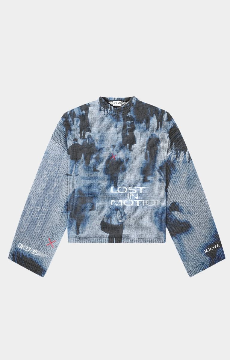 The JETLYFE Lost in Motion Blue Graphic Knit Sweater stands out with a washed blue and grey palette, blurred silhouette artwork, white front lettering, red accent marks and signature sleeve details. Designed with a crew neckline, long sleeves and ribbed trims, this expressive knit pairs easily with relaxed denim, cargo trousers and contemporary streetwear looks.