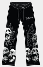 Majestik men’s black tapestry pants front view with skull branding and rhinestone detail. 
