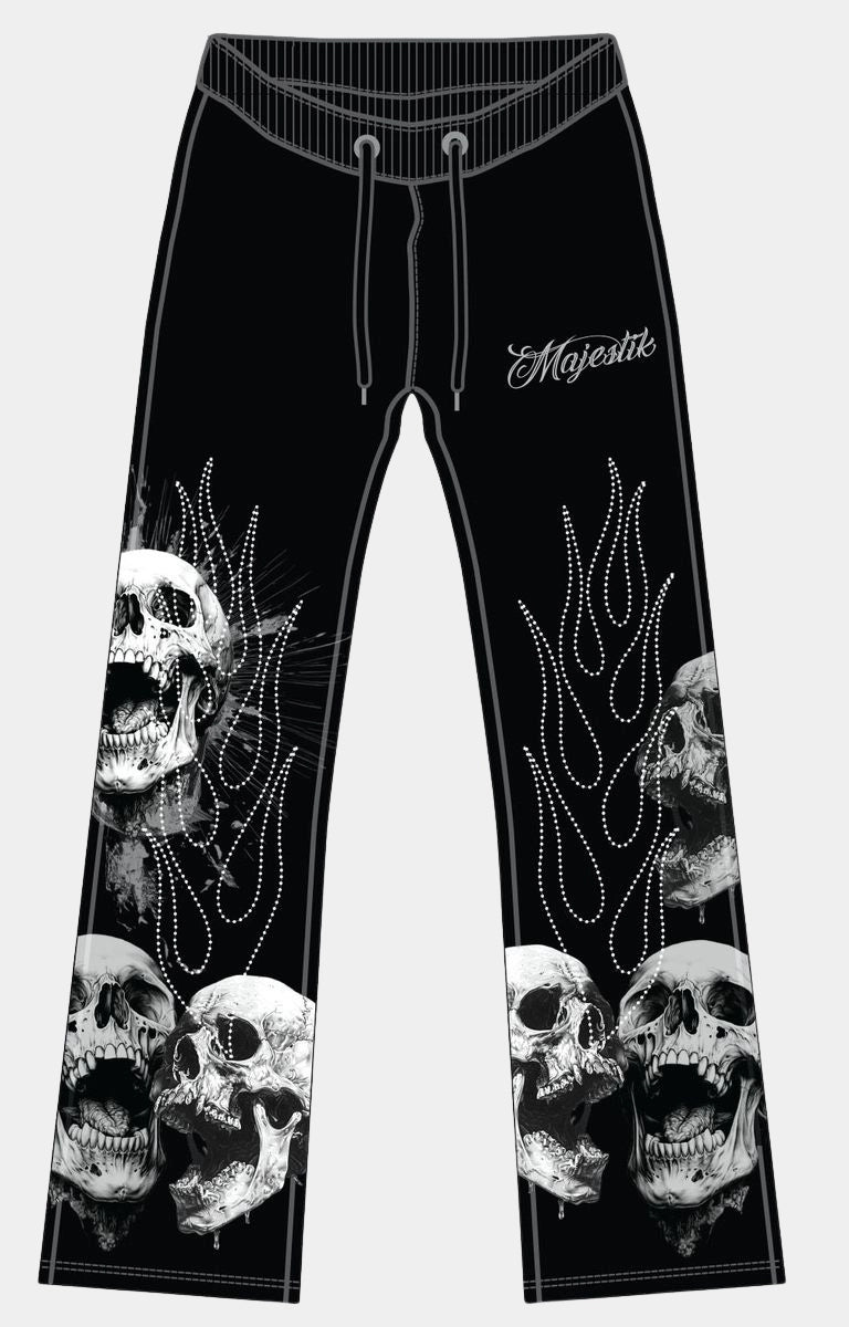 Majestik men’s black tapestry pants front view with skull branding and rhinestone detail. 