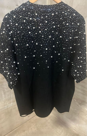 back view showing cropped fit and oversized streetwear silhouette.