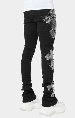 Side angle of black crystal cross jeans with stacked silhouette.