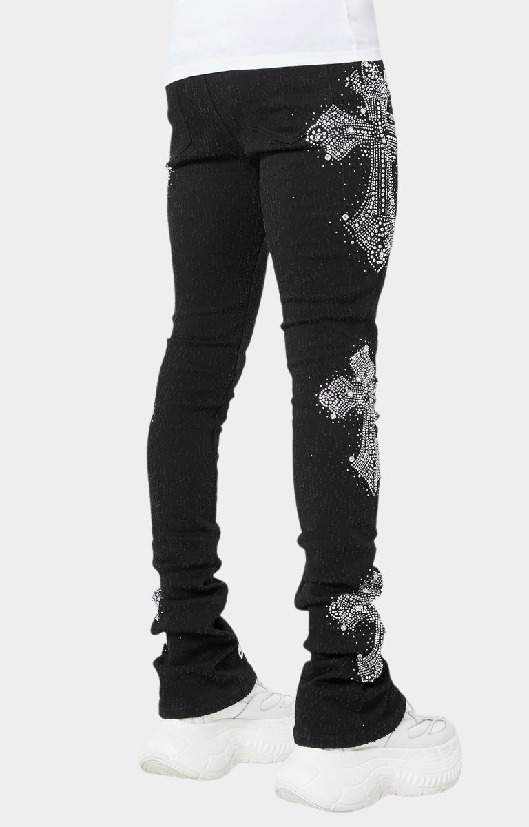 Side angle of black crystal cross jeans with stacked silhouette.