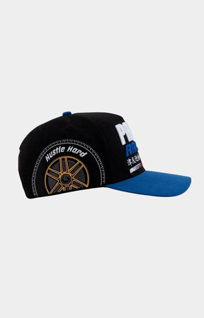 Side view showing racing car and trophy embroidery on Paper Money hat.