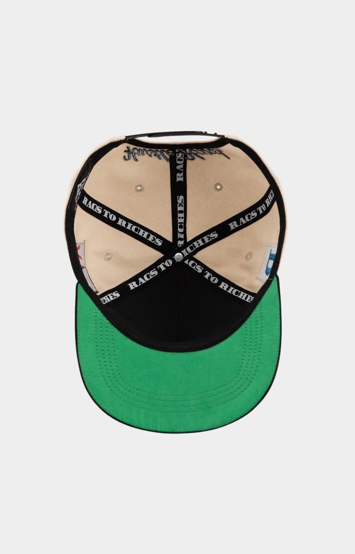 Adjustable snapback closure on Paper Money cream cap.