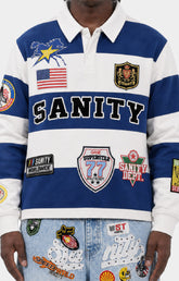 Politics Shirt Casa in blue featuring a 100% cotton construction, blue and white striped design, long sleeves, classic polo collar, SANITY lettering, and detailed embroidered patches.