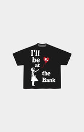 Red Letters black short-sleeve at the bank t-shirt with a graphic print on the front. The design features the text 'I'll be at the Bank' in white, a white silhouette of a person holding a red heart-shaped balloon, and the initials 'RL' inside the red heart.